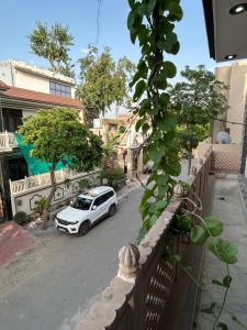 a white car parked on the side of a street at Prabhukripa Vilas Homestay in Mathura