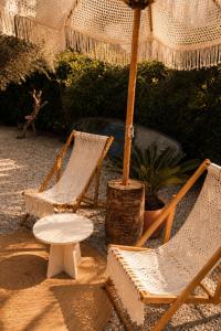 two chairs and a table and an umbrella at Gammi Hayıtbükü in Datca
