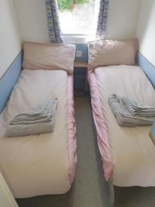 two bunk beds in a small room with a window at Skipper's Place in Mortehoe +28 photos