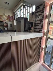 a kitchen with a counter with a computer on it at Prabhukripa Vilas Homestay in Mathura