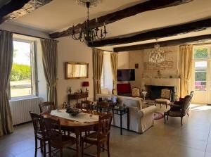 a living room with a couch and a table at Le Clos Cecile'Ann in Fréchou