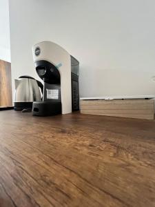 a printer sitting on top of a wooden floor at Foresteria Lombarda Pavia in Pavia