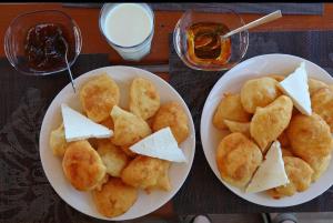 two white plates of food on a table at Guest house Niko in Çerem