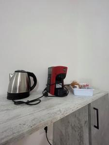 a toaster and a tea kettle sitting on a counter at Foresteria Lombarda Pavia in Pavia +24 photos