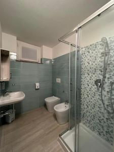 a bathroom with a shower and a toilet and a sink at Foresteria Lombarda Pavia in Pavia