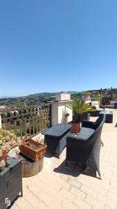 a patio with chairs and tables on a roof at Residence Villa Savoia in Marino +51 photos