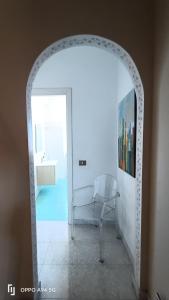 an archway in a room with a chair and a sink at Residence Villa Savoia in Marino