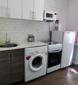 a kitchen with a washing machine and a sink at Сдается квартира у Озера in Balqash