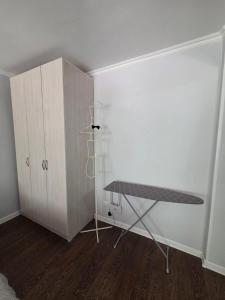 a room with a table next to a cabinet at Сдается квартира у Озера in Balqash