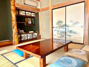 a living room with a table and a large window at 373アルプスの風 - 最大11名 in Minami Alps