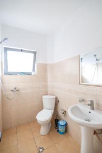 a bathroom with a toilet and a sink at Hotel Primavera in Sarandë +38 photos
