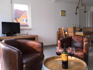 two glasses of wine on a table in a living room at Strandläufer in Breege