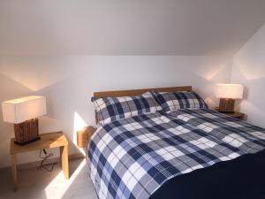 a bedroom with a blue and white checkered bed at Strandläufer in Breege