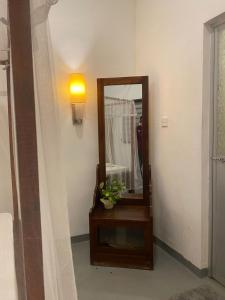 a mirror sitting on a table in a room at Kingly Aroma in Arugam Bay