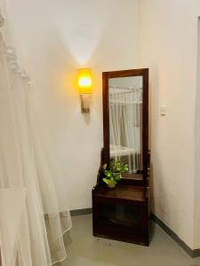 a mirror and a dresser in a room at Kingly Aroma in Arugam Bay