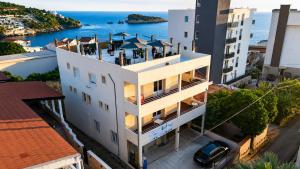 an apartment building with a balcony overlooking the ocean at Apartments and Studios Anicic in Utjeha +59 photos