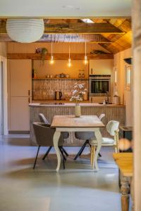 a kitchen and dining room with a table and chairs at Boerderij 1811 in Harich
