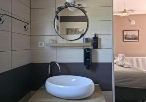 a bathroom with a sink and a mirror at Sobe - Klet Cinkuš in Hrvatski Leskovac +23 photos