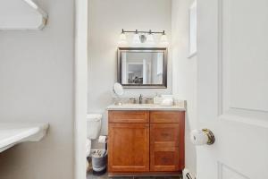a bathroom with a sink and a mirror and a toilet at Beaver Creek Bungalow in Edwards +43 photos