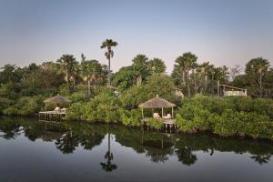 a resort with two gazebos on a body of water at Souimanga Lodge in Fimela