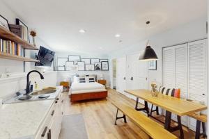 a kitchen and living room with a table and a bed at Beaver Creek Bungalow in Edwards