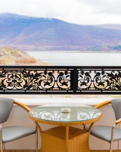a table and chairs on a balcony with a view at Oruci hotel in Kukës