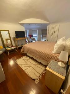 a bedroom with a bed and a table with a mirror at Villa Alessandra in Colle Isarco