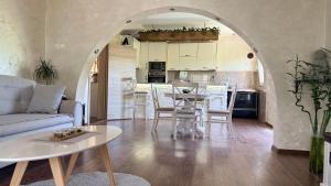 a living room and kitchen with a table and chairs at SARA in Ðuranovići