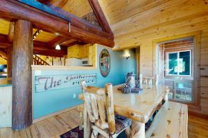 a dining room with a wooden table and chairs at Rivercrest in South Fork