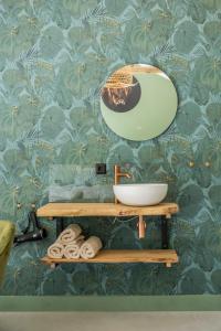a bathroom with a sink and a mirror on a wall at Boerderij 1811 in Harich +28 photos