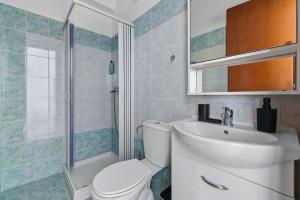a bathroom with a toilet and a sink and a shower at Celestial Luxury Residences in Ixia