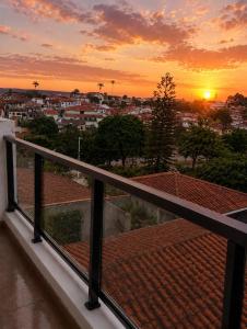 a view of a sunset from the balcony of a house at Pousada Yeshua in Paracatu