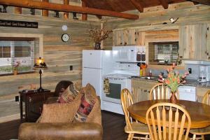a kitchen and living room with a table and a stove at Mountain View Cabin in South Fork