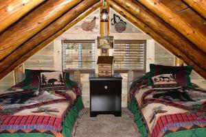 a bedroom with two beds in a attic at Mountain View Cabin in South Fork