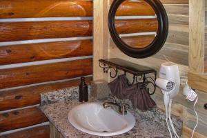 a bathroom with a sink and a mirror at Mountain View Cabin in South Fork +35 photos