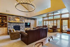 a living room with a couch and a fireplace at Lion Square Lodge East 310 in Vail