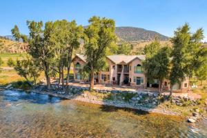 an aerial view of a house next to a river at Grande Getaway in South Fork