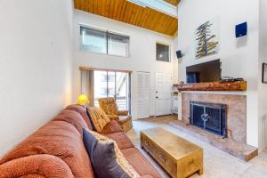 a living room with a couch and a fireplace at Emmons Escape & Cozy Slopeside Condo in Crested Butte