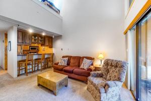 a living room with a couch and a table at Emmons Escape & Cozy Slopeside Condo in Crested Butte +20 photos
