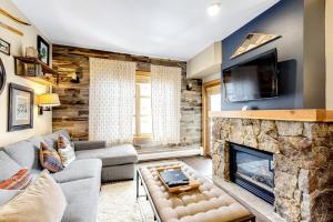 a living room with a couch and a fireplace at Passage Point 521 in Frisco
