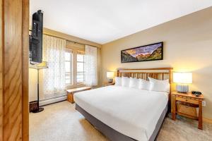 a hotel room with a bed and a television at Passage Point 521 in Frisco +24 photos