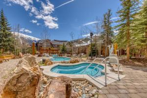 a swimming pool in a yard with a mountain at Passage Point 521 in Frisco