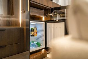 an open refrigerator with drinks inside of it at Una Rooms in Poreč