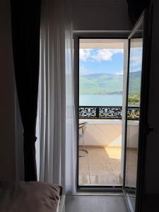 a bedroom with a view of the ocean from a window at Oruci hotel in Kukës