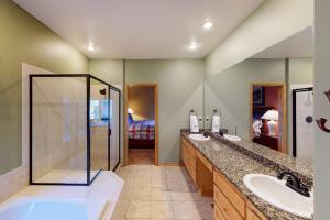 a large bathroom with two sinks and a shower at Teller Townhomes 106 in Frisco +43 photos