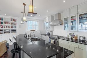 a kitchen with white cabinets and a black counter top at Telluride Memories in Telluride