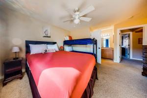 a bedroom with a bed and a ceiling fan at Firelight Chalet 94 in Big Sky