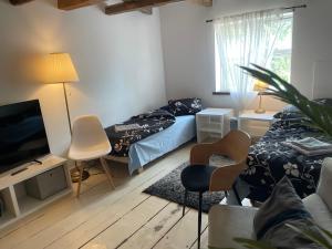 a living room with two beds and a television at Renthouse Rest & Go Paide in Paide