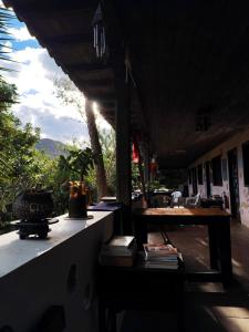 a patio with a table and some plants on it at Matilda Ec in Vilcabamba
