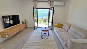 a living room with a couch and a table at Villa Sava in Đenovići